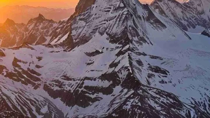 A snow-covered peak catching the last of the sunset